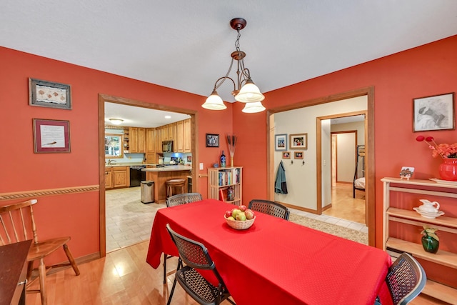 dining area featuring a chandelier and light hardwood / wood-style flooring