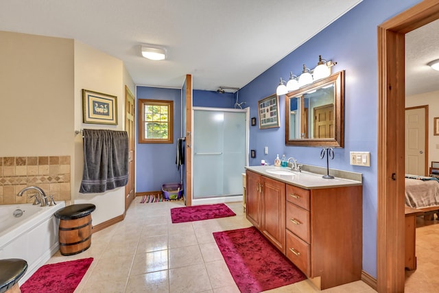 bathroom featuring tile patterned flooring, vanity, a textured ceiling, and independent shower and bath