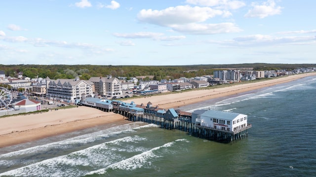 drone / aerial view with a beach view and a water view