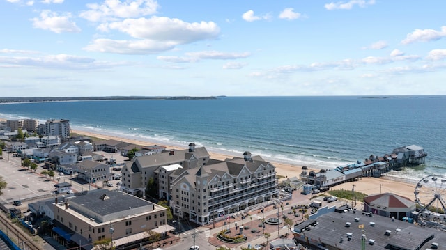 bird's eye view featuring a water view and a beach view