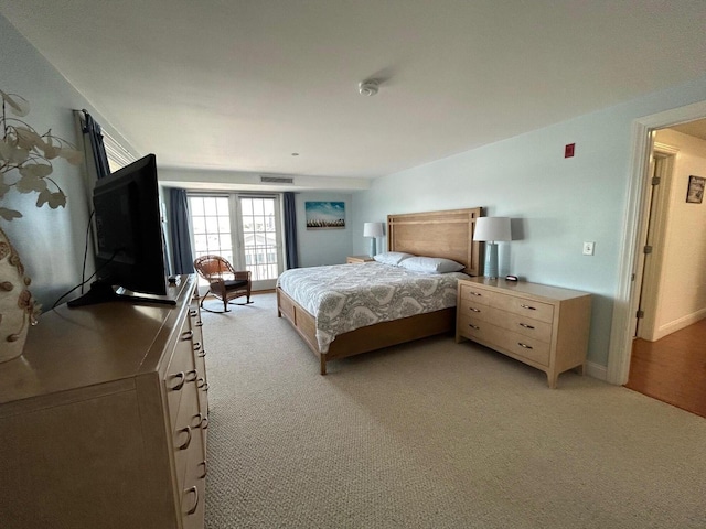 bedroom featuring light carpet