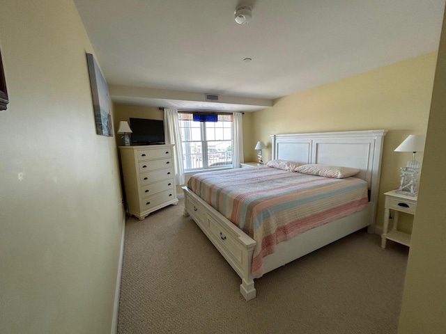 bedroom featuring light carpet