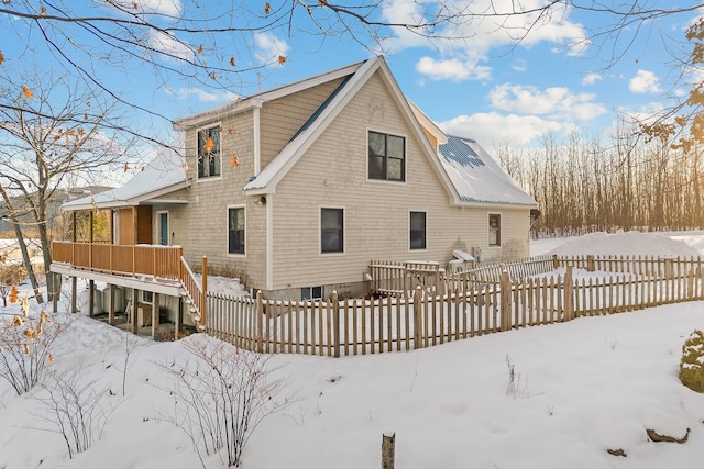 view of snow covered back of property