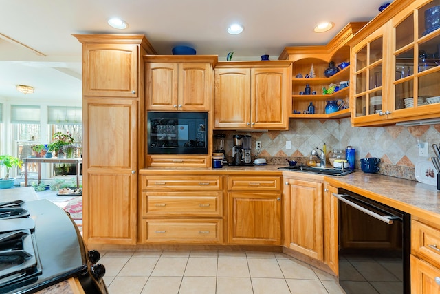 kitchen featuring black appliances, backsplash, light tile patterned floors, and sink