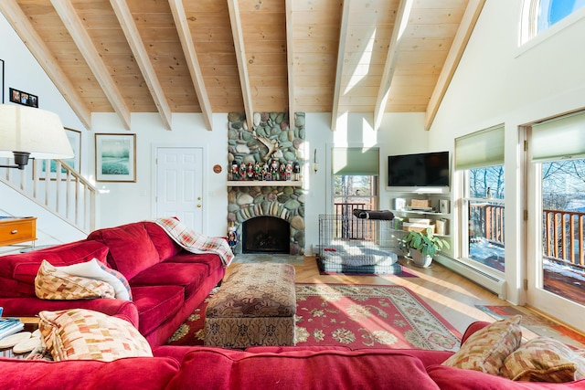 living room with baseboard heating, beamed ceiling, high vaulted ceiling, a fireplace, and wood ceiling