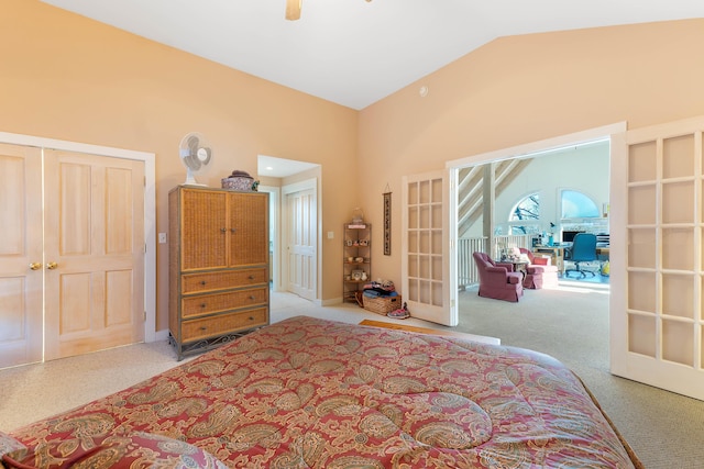 carpeted bedroom with a closet, ceiling fan, french doors, and lofted ceiling