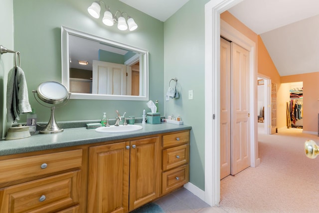 bathroom with vanity and vaulted ceiling