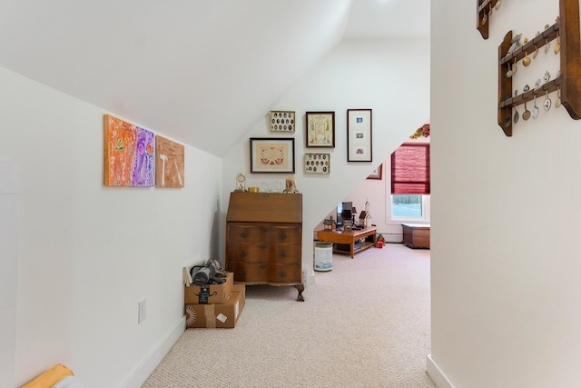 hallway featuring carpet flooring and lofted ceiling