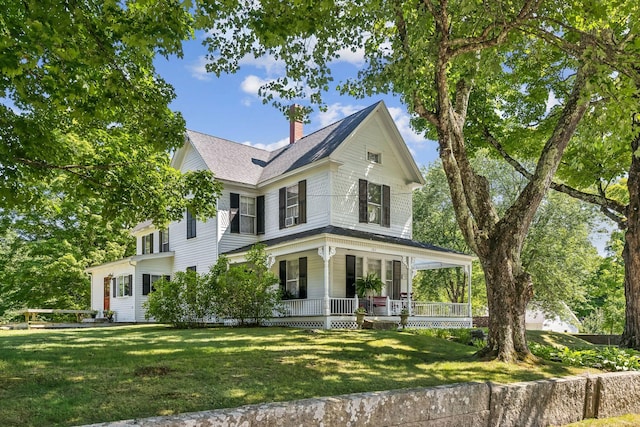 view of front facade with a front lawn and a porch