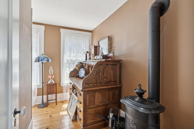 interior details featuring a wood stove and hardwood / wood-style floors