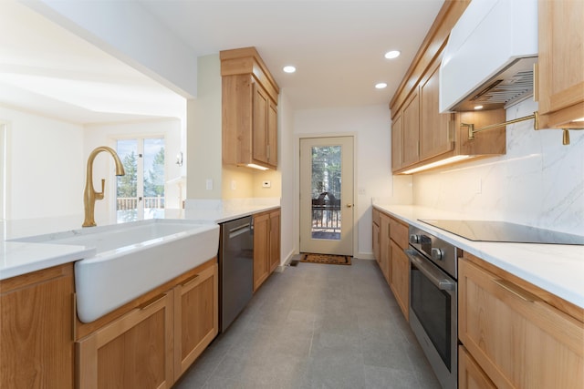 kitchen featuring light brown cabinets, stainless steel appliances, custom range hood, and sink