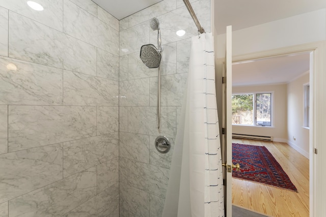 bathroom with wood-type flooring, walk in shower, and a baseboard heating unit