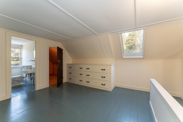 additional living space featuring dark hardwood / wood-style floors and vaulted ceiling