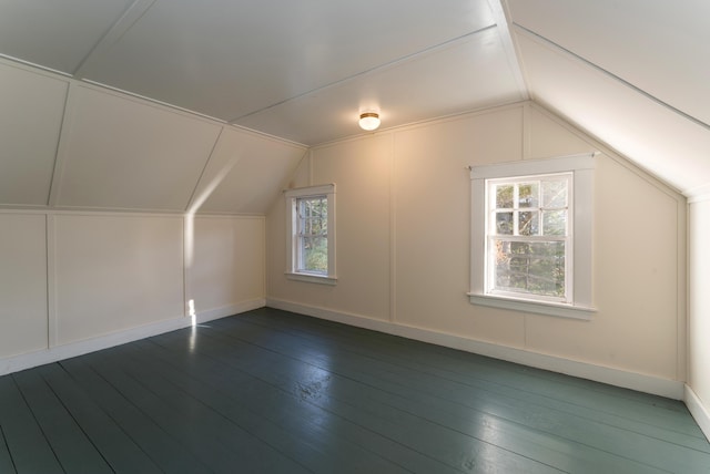 additional living space featuring hardwood / wood-style floors and vaulted ceiling