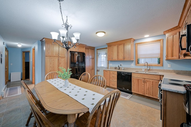 kitchen featuring sink, a notable chandelier, plenty of natural light, pendant lighting, and black appliances