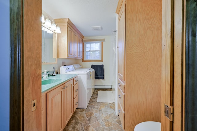 laundry area featuring a baseboard radiator and washing machine and clothes dryer