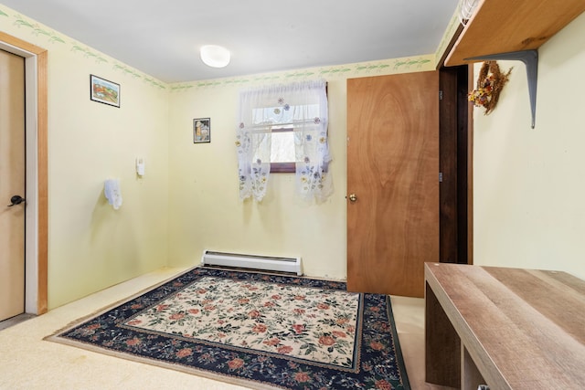 foyer entrance featuring a baseboard heating unit