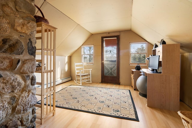 interior space with a healthy amount of sunlight, light hardwood / wood-style flooring, baseboard heating, and lofted ceiling