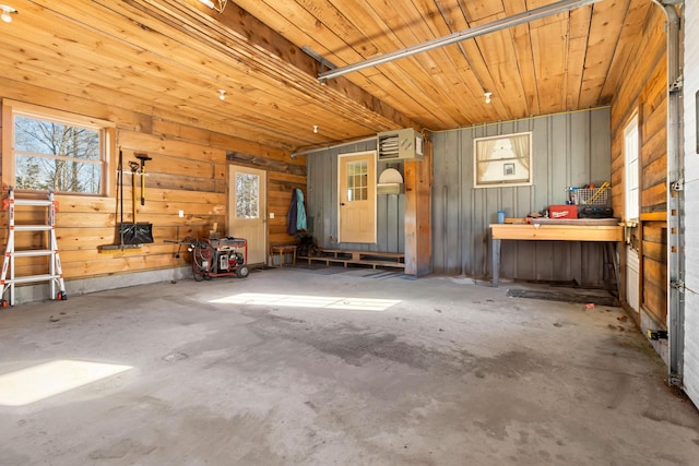 interior space with wood walls and concrete flooring