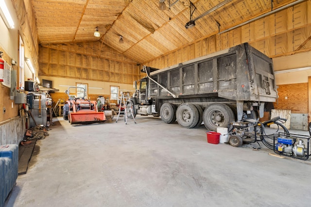 garage featuring a carport and wooden walls