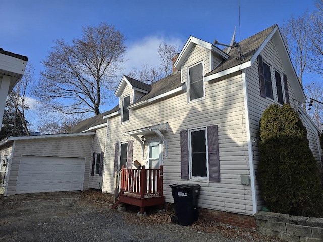 cape cod house featuring a garage