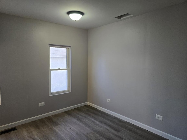 unfurnished room featuring dark wood-type flooring