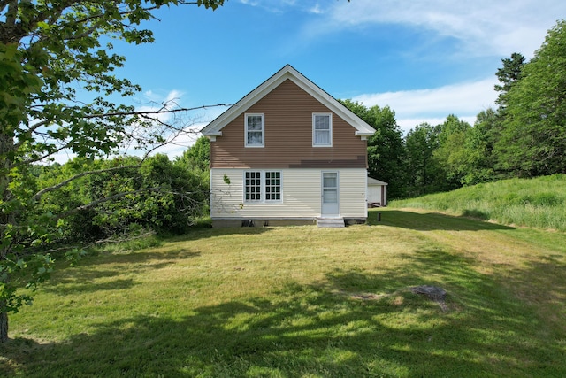 back of house featuring a lawn