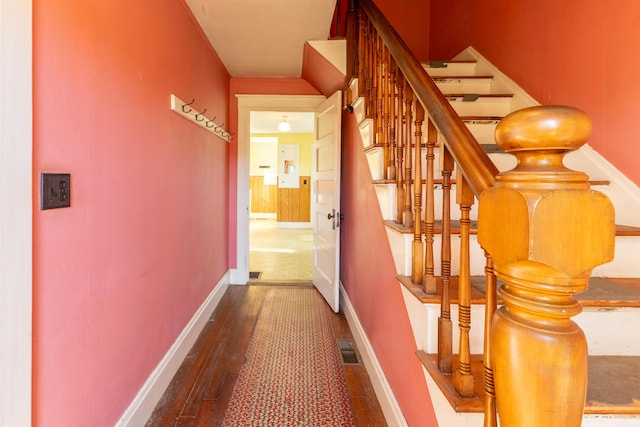 corridor with hardwood / wood-style floors