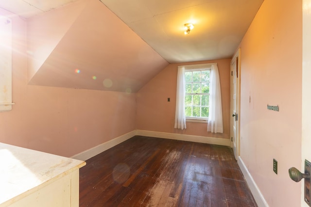 bonus room featuring dark wood-type flooring and vaulted ceiling