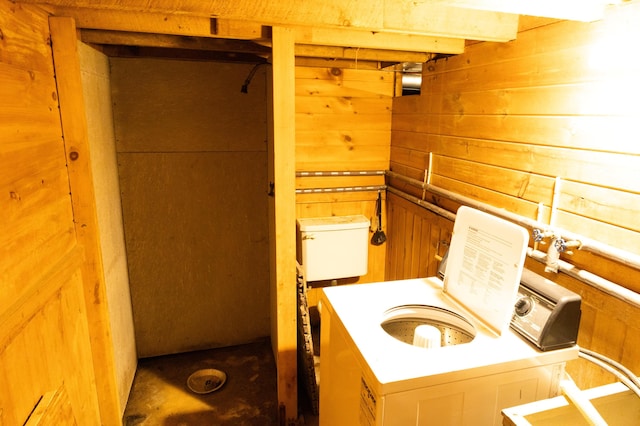 bathroom with beamed ceiling and wooden walls