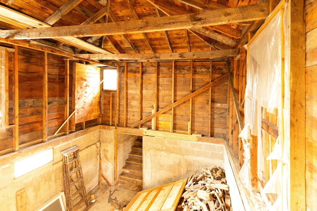 misc room featuring wooden ceiling, lofted ceiling, and wood walls