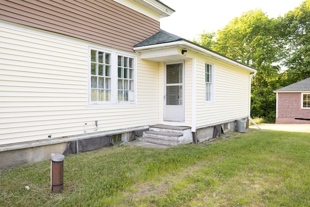 entrance to property with a lawn