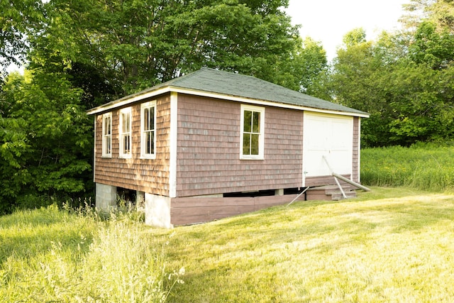 view of outbuilding with a lawn