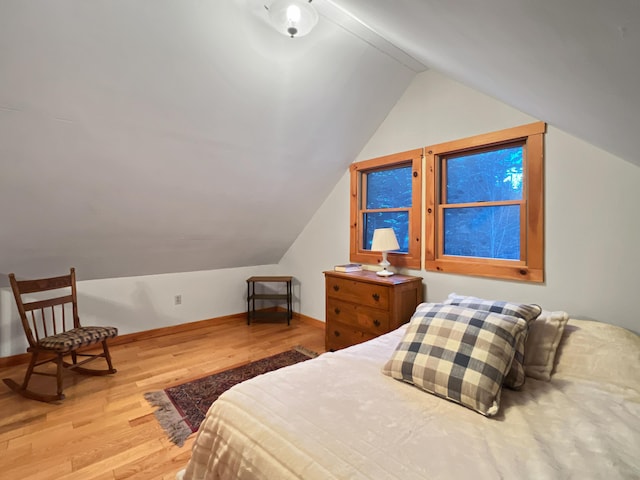 11 Crows Rd, Greenville, ME 04441 - bedroom with lofted ceiling, wood finished floors, and baseboards