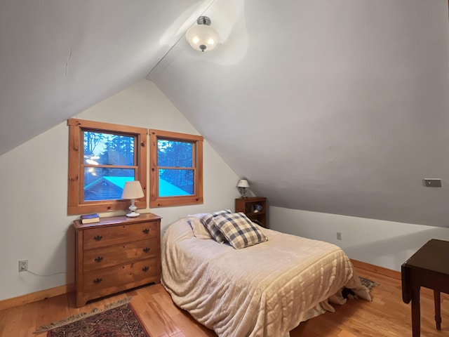 11 Crows Rd, Greenville, ME 04441 - bedroom with light wood-style floors, baseboards, and lofted ceiling