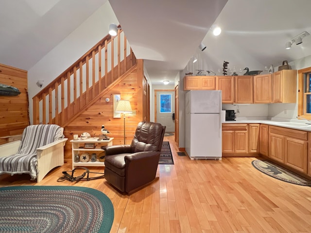 11 Crows Rd, Greenville, ME 04441 - living area featuring wooden walls, light wood-style flooring, stairs, and lofted ceiling