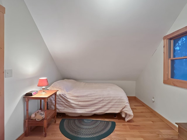 11 Crows Rd, Greenville, ME 04441 - bedroom featuring light wood-style flooring, baseboards, and vaulted ceiling