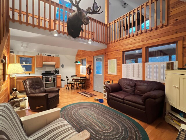 11 Crows Rd, Greenville, ME 04441 - living area featuring a high ceiling, light wood finished floors, and wood walls