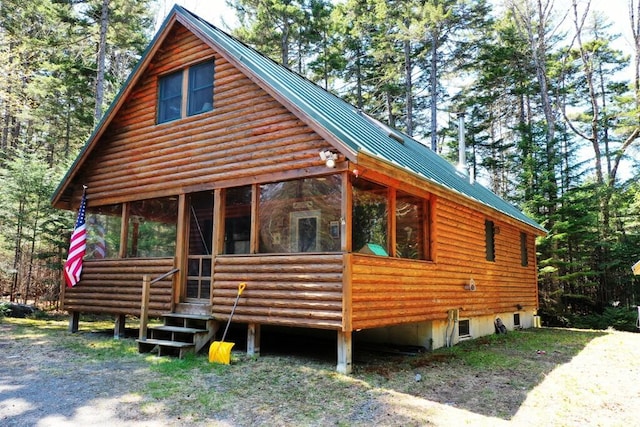 11 Crows Rd, Greenville, ME 04441 - view of front of home with a sunroom and metal roof