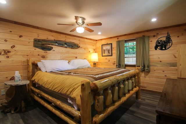 bedroom with wood walls, dark hardwood / wood-style floors, and ceiling fan