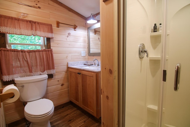 bathroom featuring vanity, lofted ceiling, wooden walls, hardwood / wood-style flooring, and walk in shower