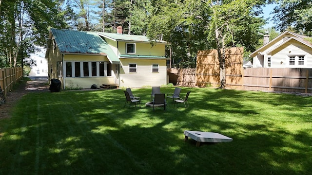 back of house featuring a lawn