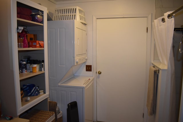 laundry area with stacked washer and dryer