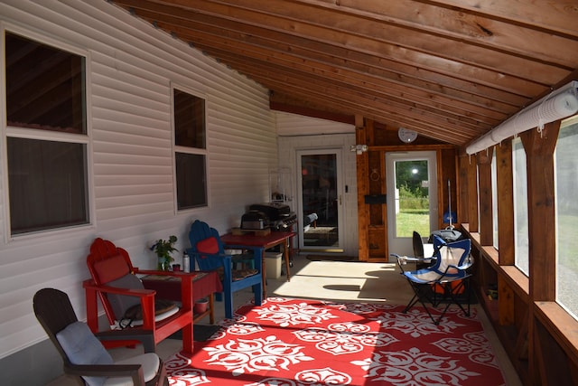 sunroom / solarium featuring lofted ceiling