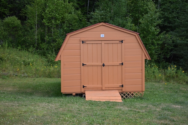 view of outdoor structure featuring a lawn