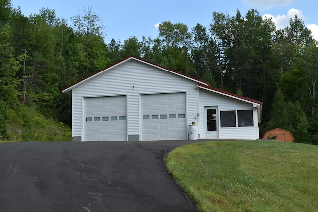 ranch-style home with an outbuilding and a garage