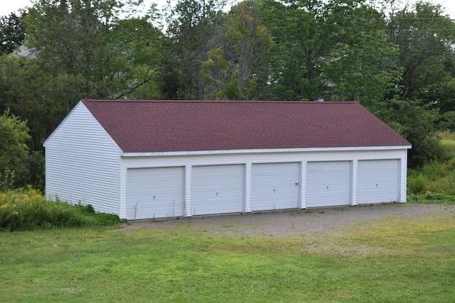 garage featuring a yard