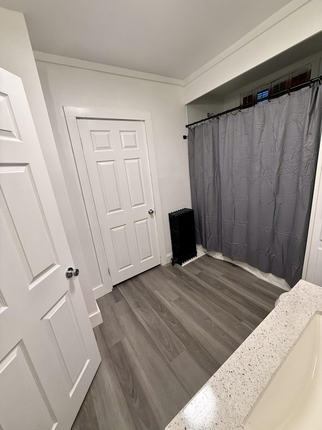 bedroom featuring dark hardwood / wood-style flooring and crown molding