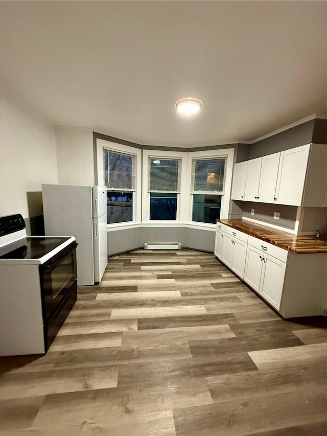 kitchen featuring black range with electric stovetop, light hardwood / wood-style floors, white cabinetry, and white fridge