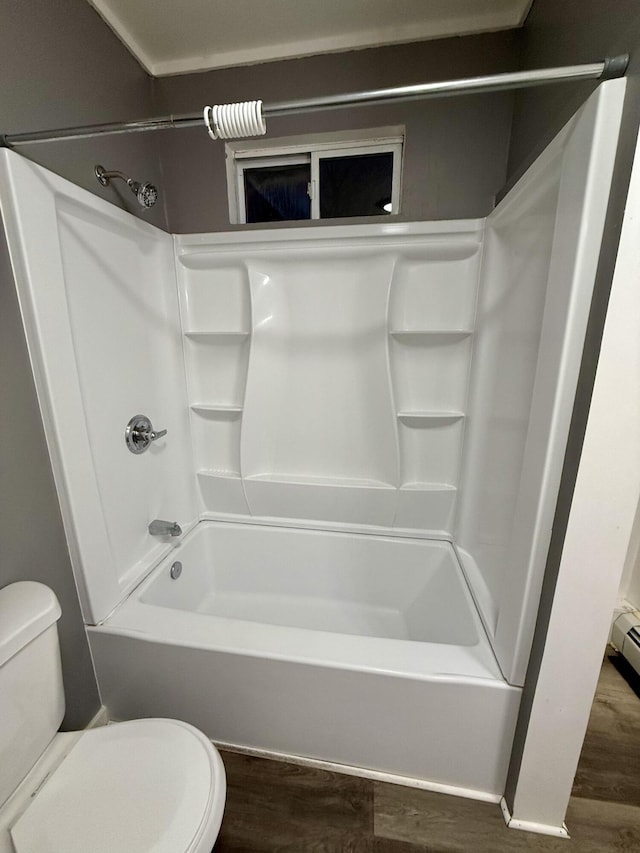 bathroom with toilet, bathing tub / shower combination, and hardwood / wood-style floors